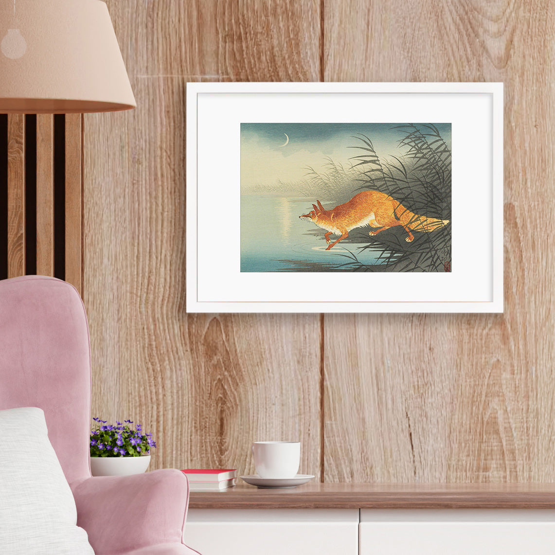 A smart modern interior showing a framed Japanese woodblock art print on the wall, featuring Ohara Koson's "Fox in the Reeds" artwork.