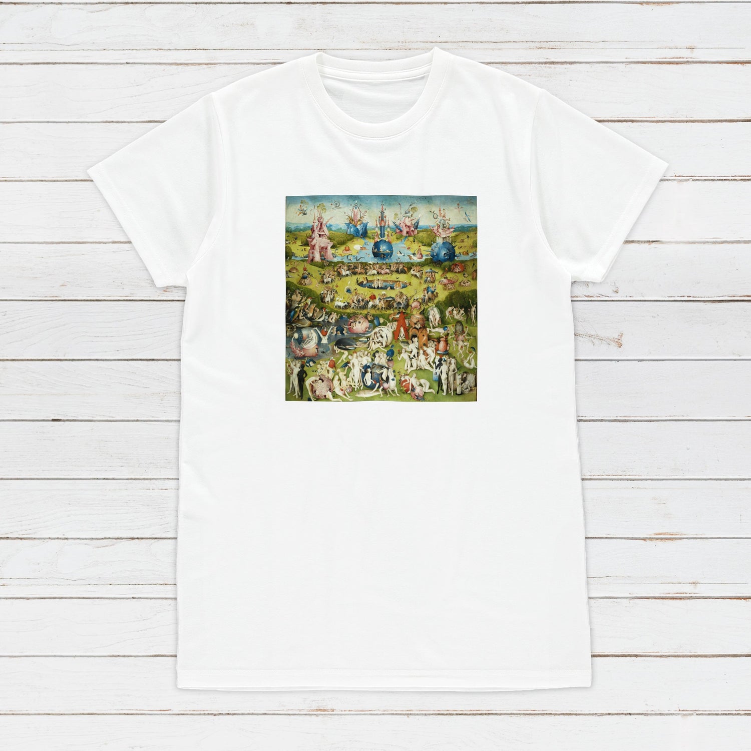 A top view of a white T Shirt featuring a print of Hieronymus Bosch's artwork "The Garden of Earthly Delights"