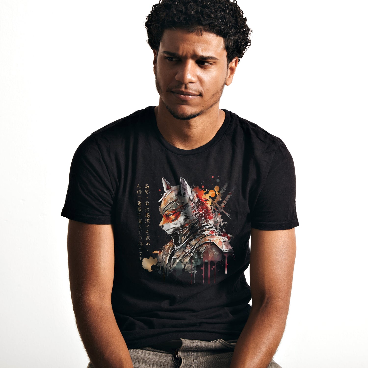 A young man wearing a black T Shirt with a Japanese "Samurai Fox" print