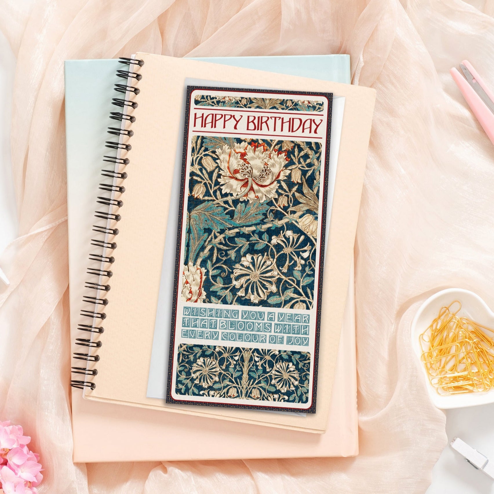 Notebook with a decorative William Morris "Honeysuckle" card on a soft pink fabric background