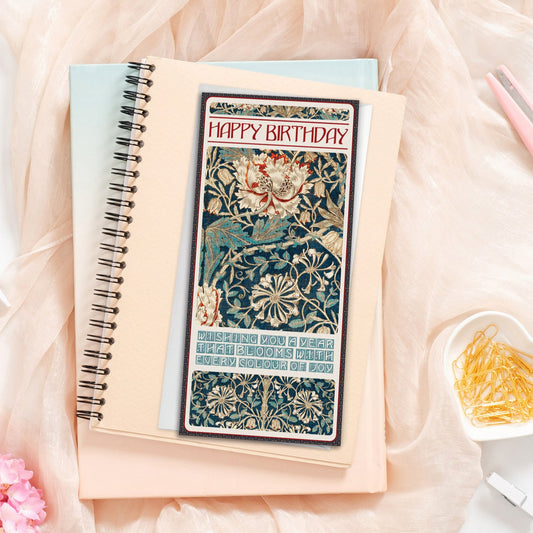 Notebook with a decorative William Morris "Honeysuckle" card on a soft pink fabric background