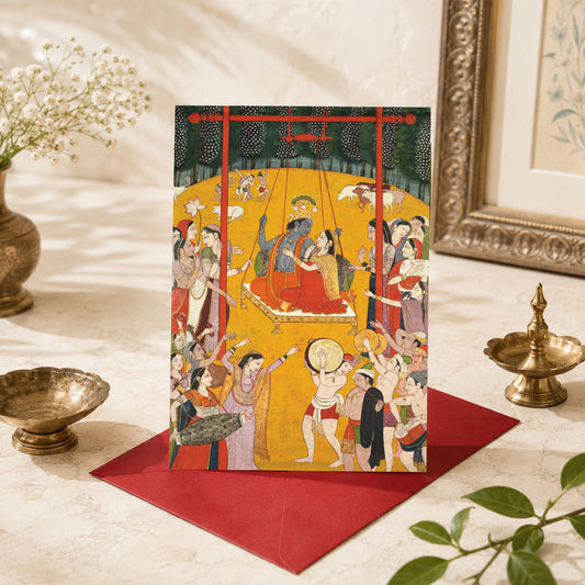 A large Indian art greeting card featuring Hindola Raga, c. 1790–1800, from the Pahari kingdoms of Northern India. A greeting card featuring a traditional Indian miniature painting scene. Radha and Krishna sit together on a swing while their companions gather around them to play music, dance and gently keep the swing in motion.