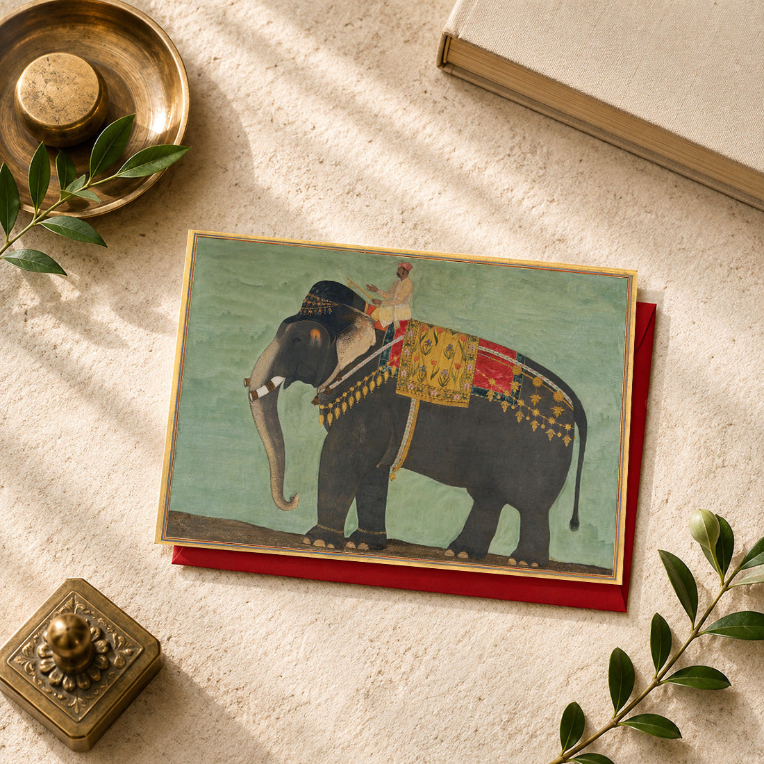 A large Indian art greeting card featuring Portrait of the Elephant ‘Alam Guman, ca. 1640, attributed to Bichitr.
Richly adorned in ceremonial trappings, ‘Alam Guman dominates this remarkable Mughal portrait with all the presence and dignity normally reserved for an important court figure. One of the celebrated elephants of the Mughal court, he is shown with extraordinary attention to detail — from his powerful form to the elaborate textiles and ornaments that mark his royal status.