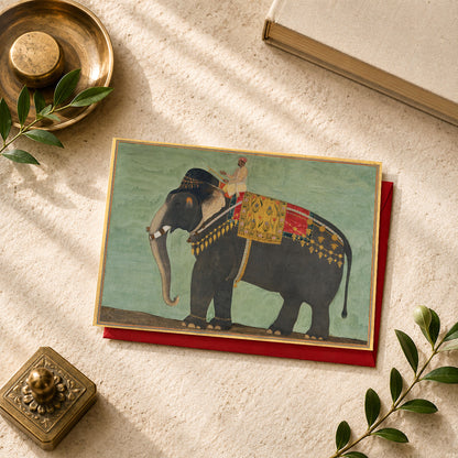 A large Indian art greeting card featuring Portrait of the Elephant ‘Alam Guman, ca. 1640, attributed to Bichitr.
Richly adorned in ceremonial trappings, ‘Alam Guman dominates this remarkable Mughal portrait with all the presence and dignity normally reserved for an important court figure. One of the celebrated elephants of the Mughal court, he is shown with extraordinary attention to detail — from his powerful form to the elaborate textiles and ornaments that mark his royal status.