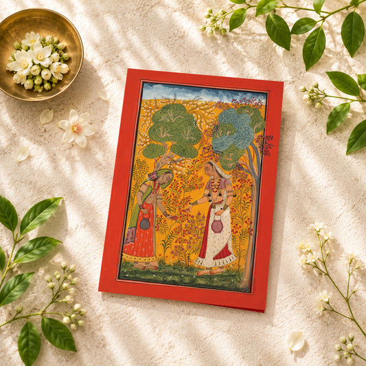 A large Indian art greeting card featuring Vasanti Ragini, ca. 1710, from a Ragamala series — a painted Garland of Musical Modes.

Two elegantly dressed women gather flowers in a radiant spring landscape, surrounded by blossoms, golden foliage and the rich colours of the season. Warm saffron, red and green tones give the scene an almost sunlit glow, while the graceful figures and delicate botanical detail create a wonderfully serene sense of abundance and renewal.